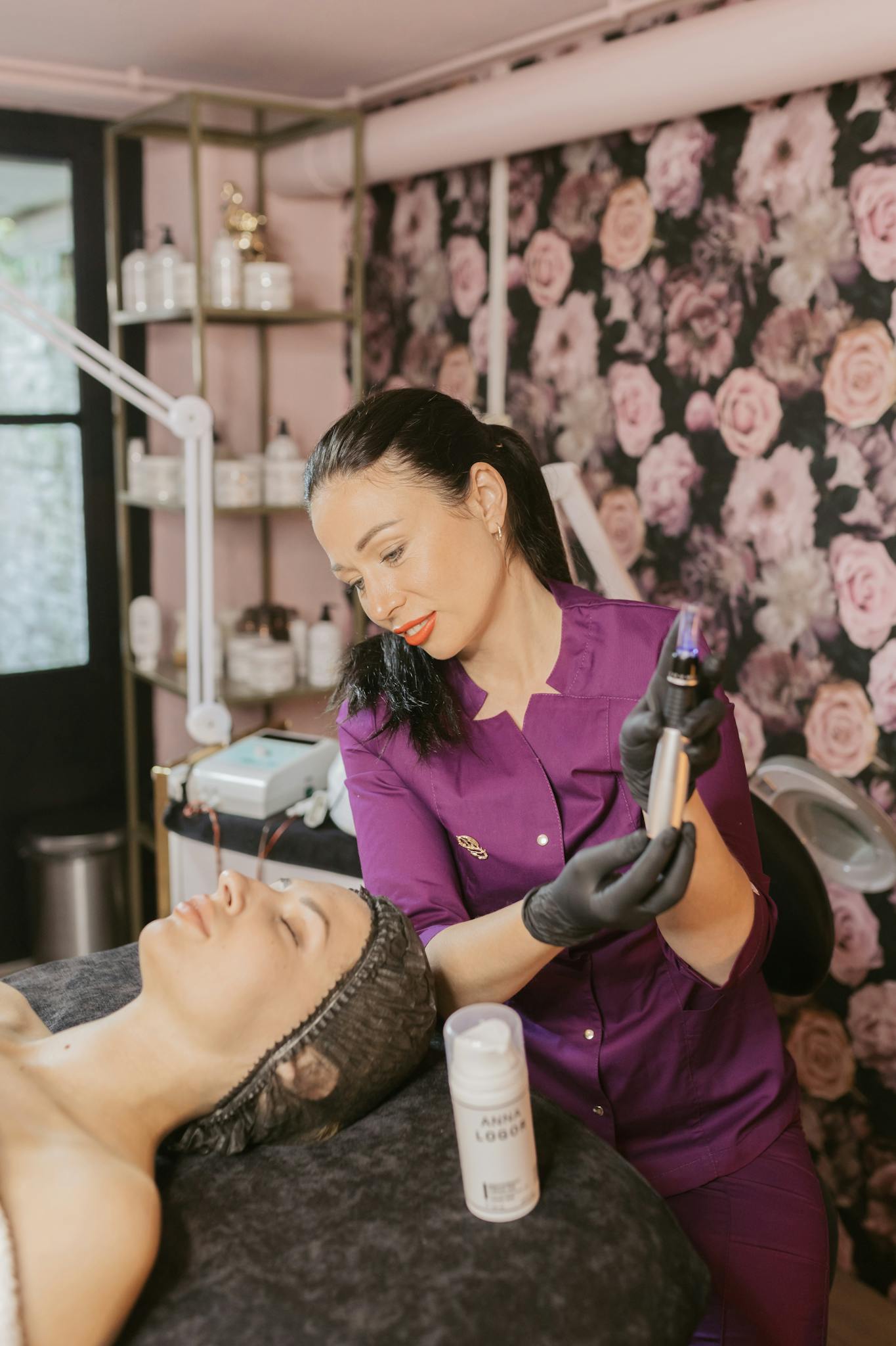 Skilled cosmetologist using modern equipment for a rejuvenating facial treatment in a spa setting.